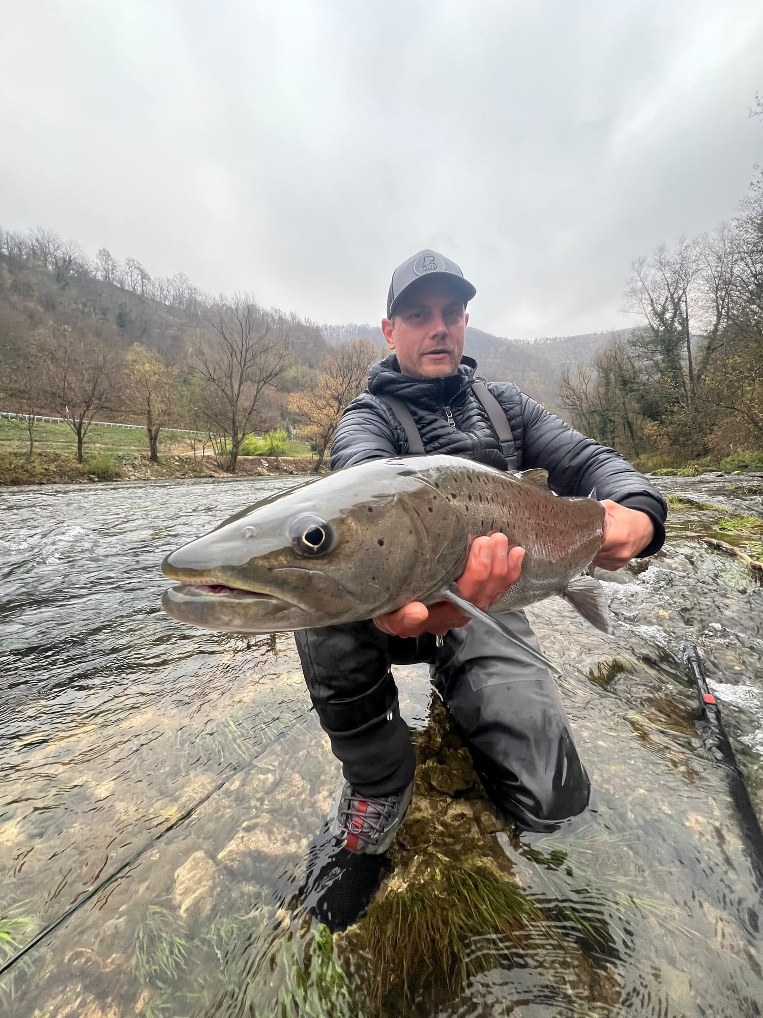 Angler lifting a fish clear of the water for a quick photo