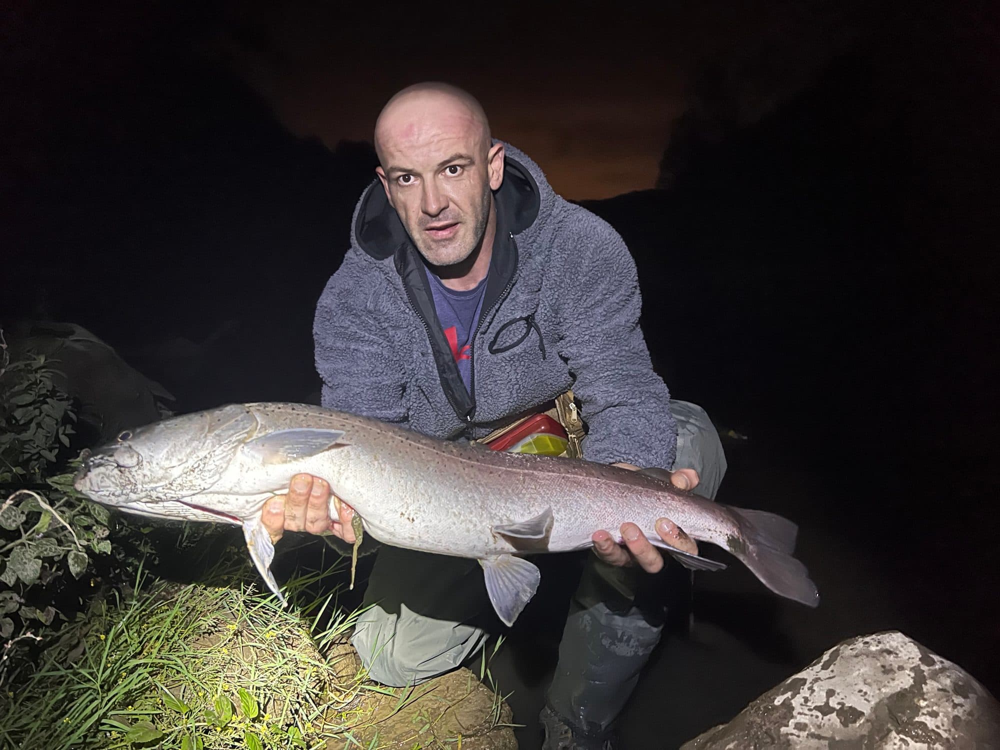 Portrait of an angler holding a large trophy fish