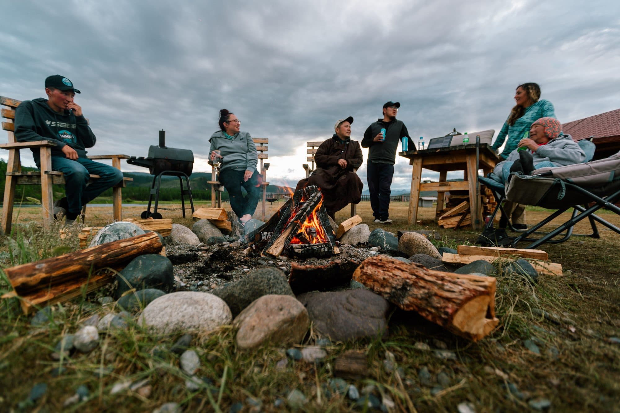 Camp cooks preparing dinner over an open fire