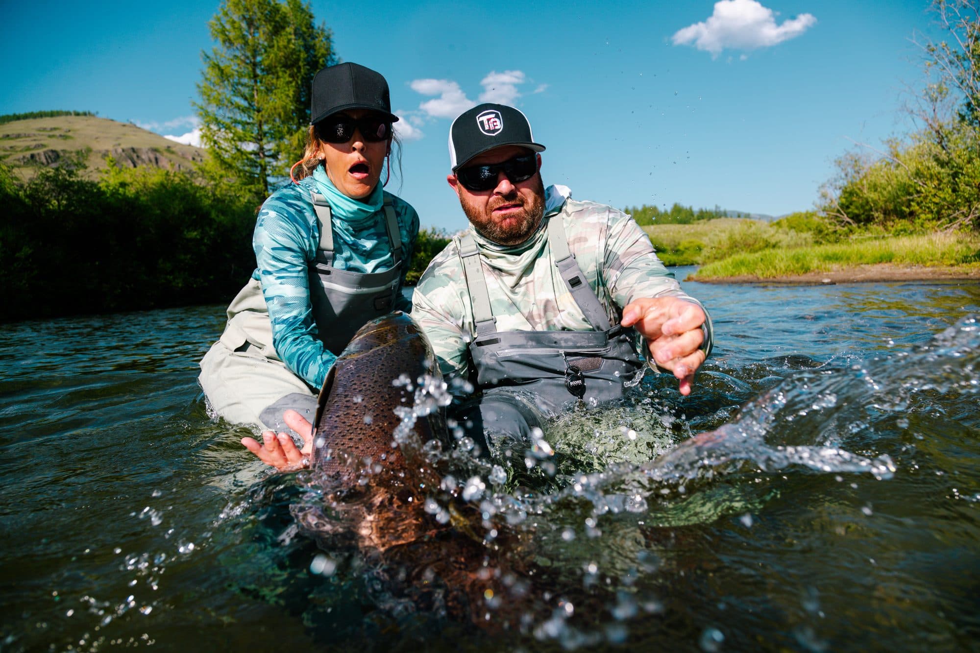 Taimen splashing back into the river on release