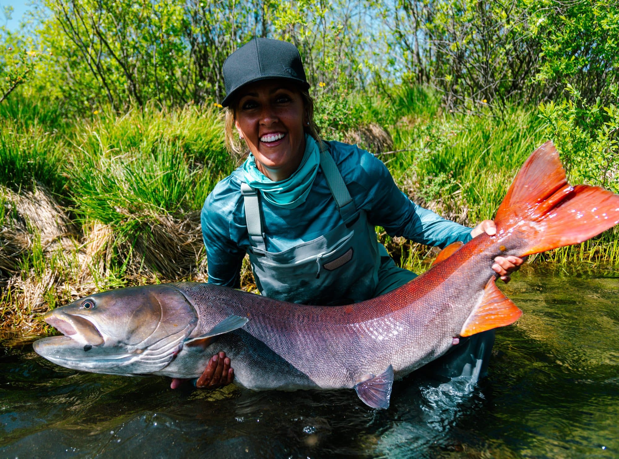 Angler laughing while holding a big taimen