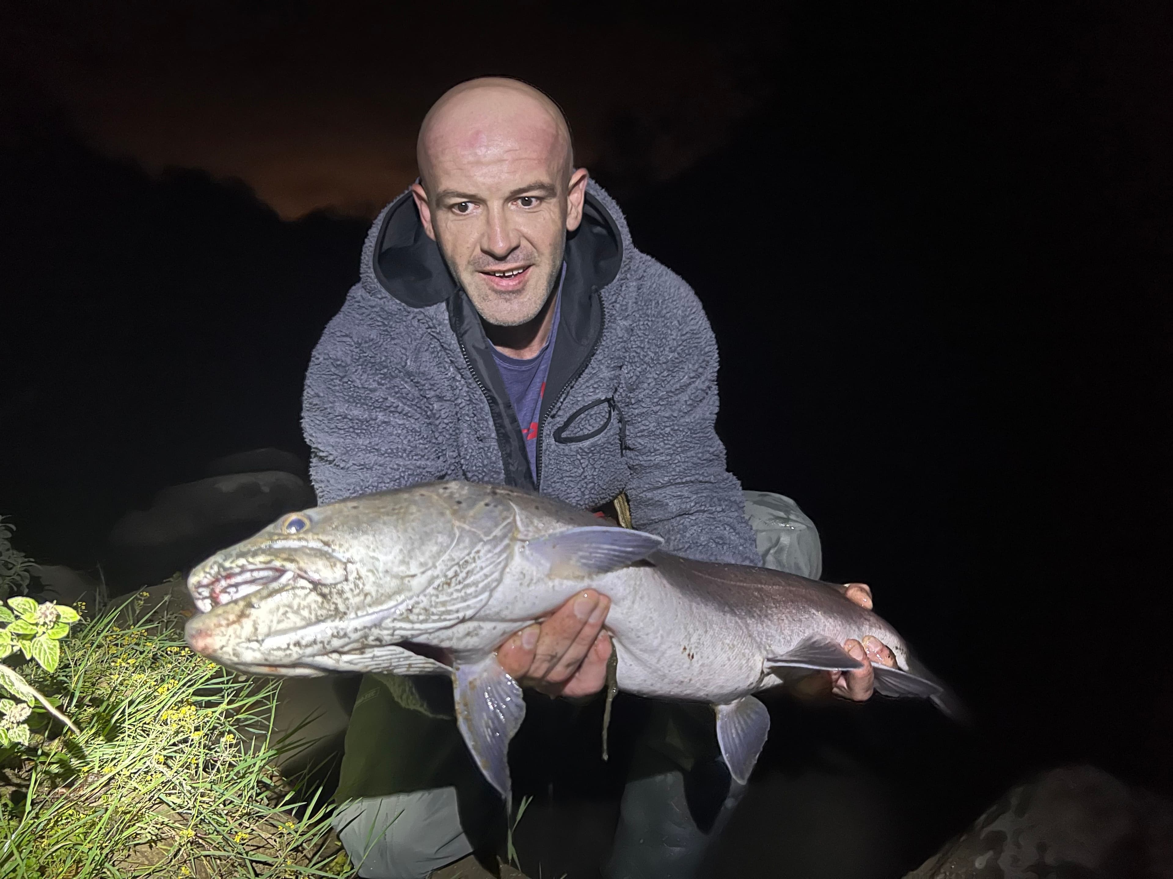 Angler with a huchen landed during a night session