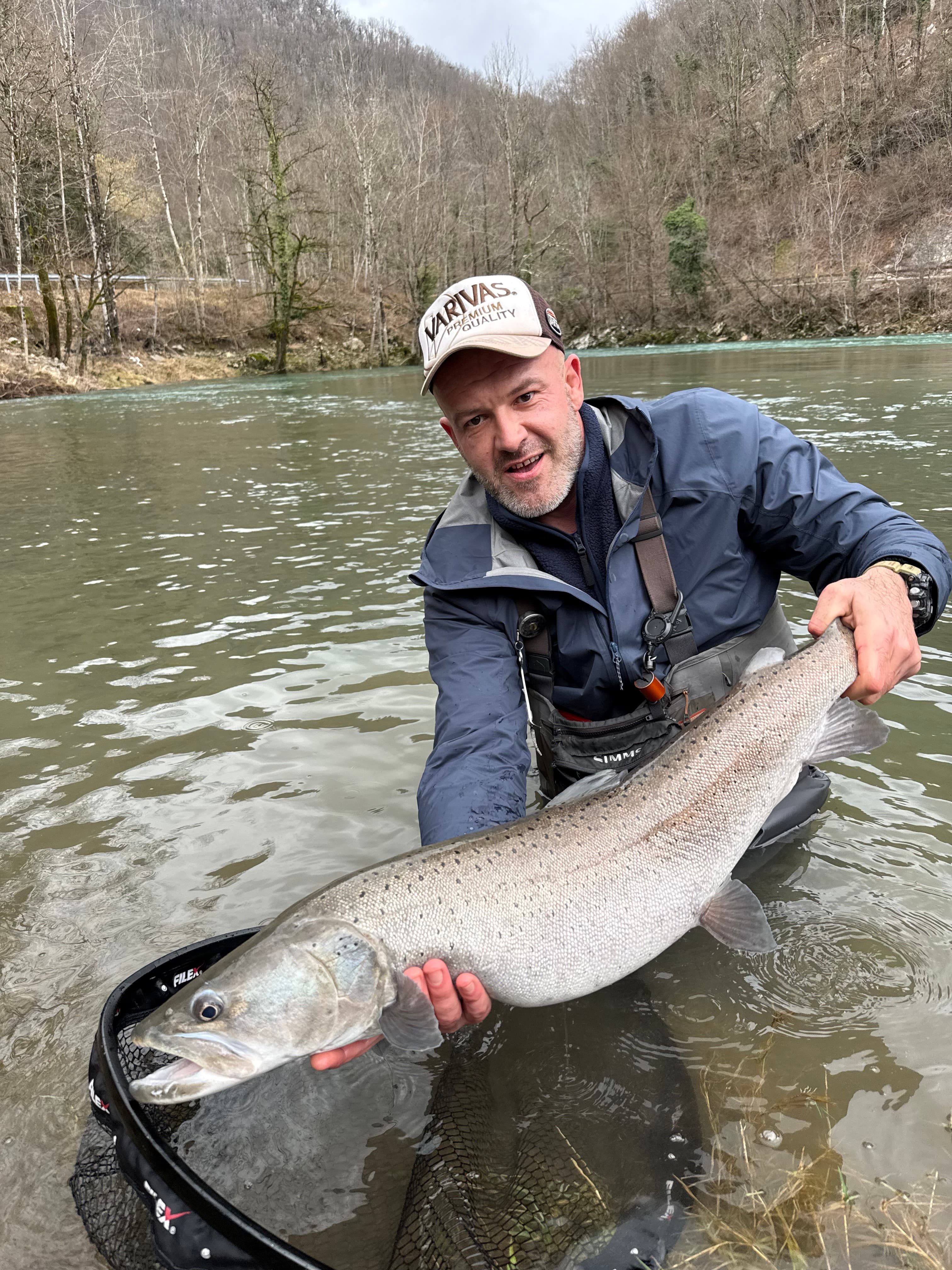 Angler holding a huge wild huchen caught on the Sana River